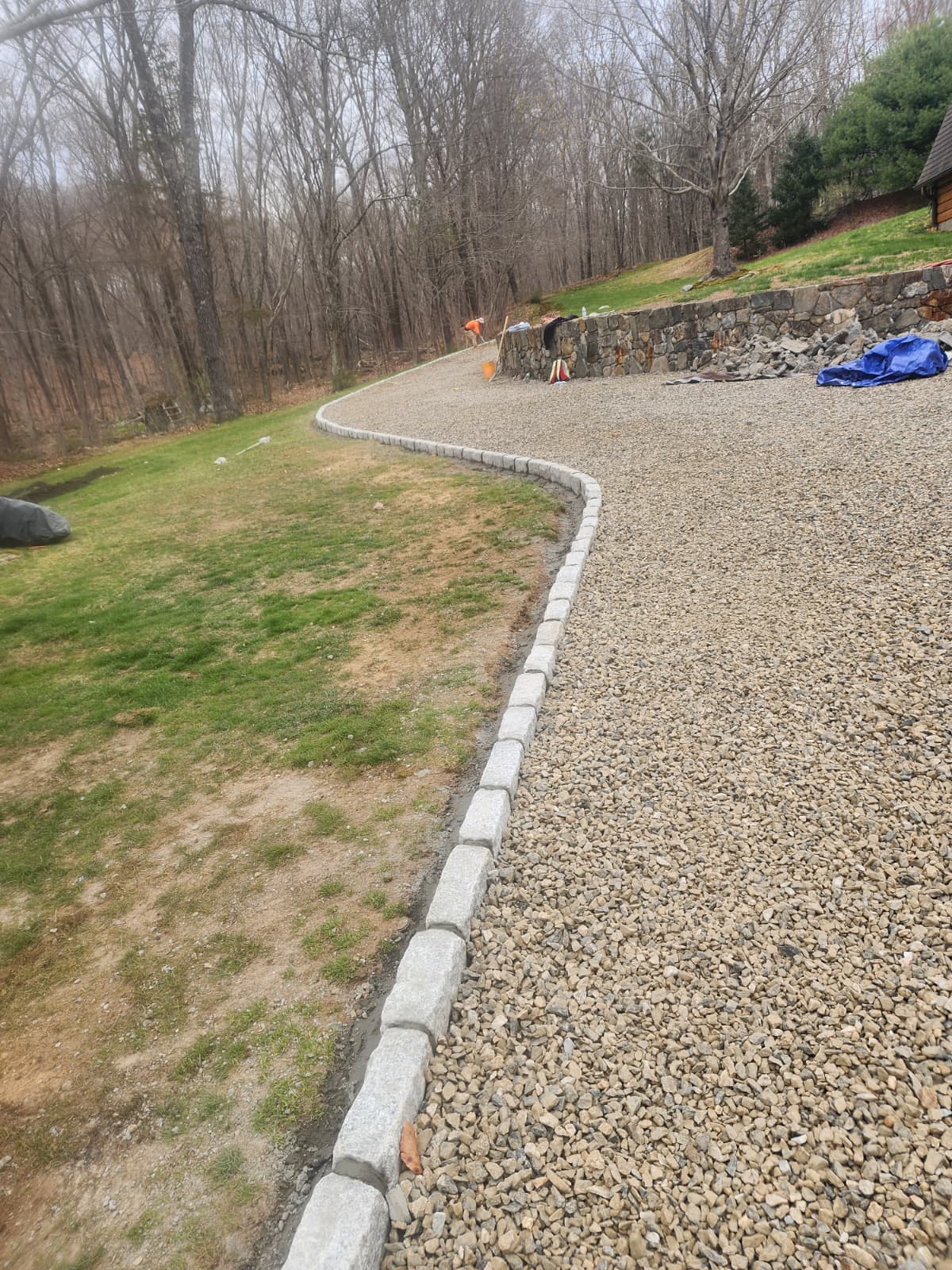 Belgian block edging defining a curved gravel driveway