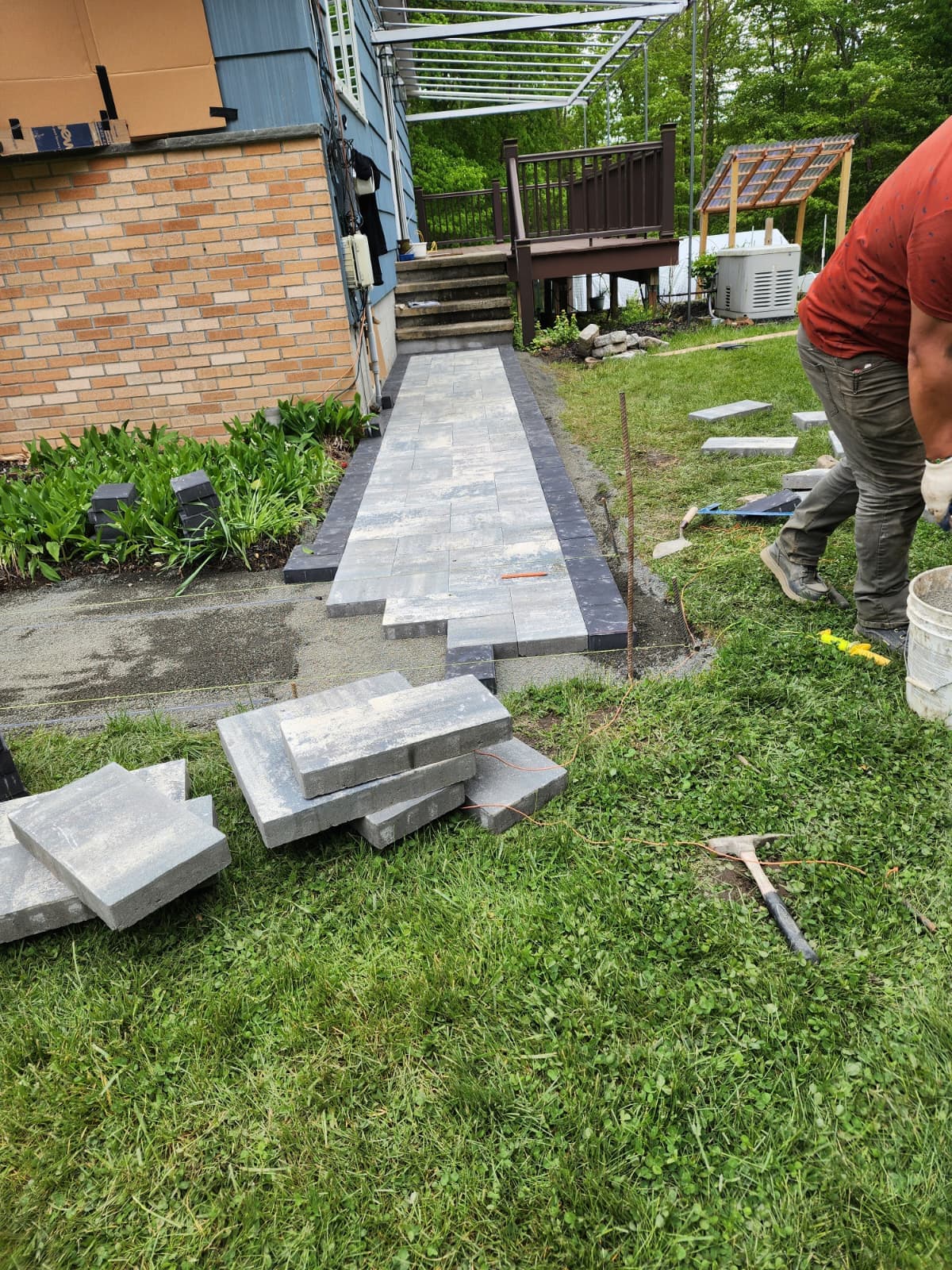 Paver walkway being installed with stone steps in progress