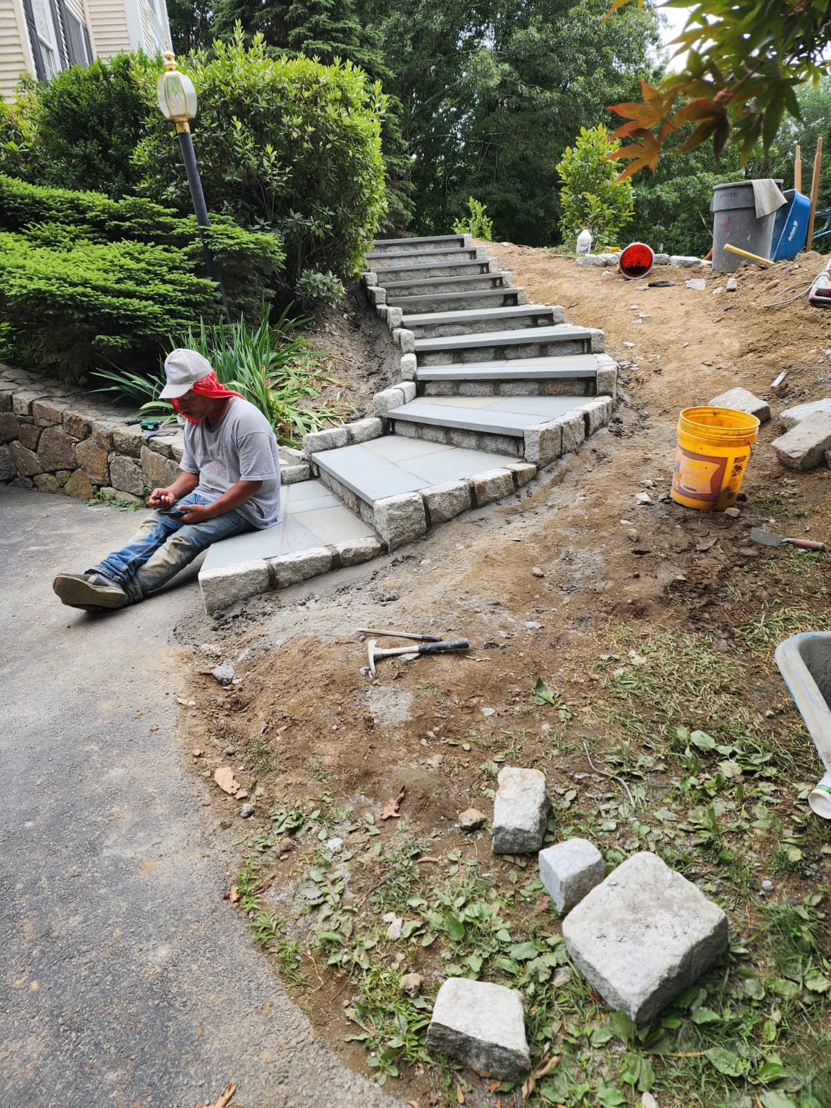 Stone steps under construction on a sloped property by Chabla's Construction